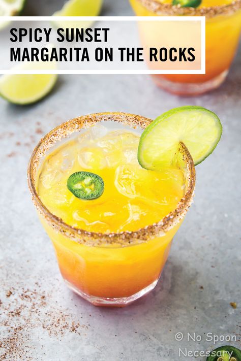 This Spicy Sunset Margarita recipe is a fruity, fiery twist on the classic Mexican cocktail. Flavored with mango, pineapple, jalapeño, and grenadine, this tropical tequila drink is sure to get the party started this summer! Fruity Margarita Recipe, Spicy Mango Margarita, Strawberry Daiquiri Recipe, Mexican Cocktail, Passion Fruit Margarita, Mexican Cocktails, Margarita On The Rocks, Pineapple Margarita, Rock Recipes