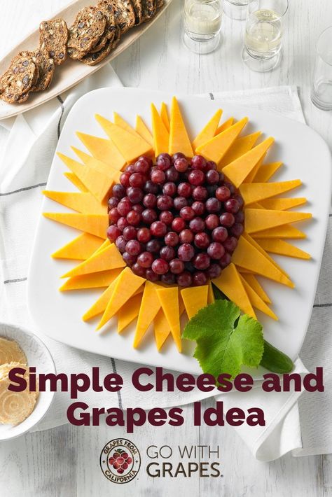 Grapes and cheese, whether on a platter, tray, or board, are the perfect combination for a simple, crowd-pleasing appetizer.  Try this sunflower arrangement with a variety of cheese and red, green, and black grapes from California. #grapes #cheese #simplerecipes #easyrecipes #entertainingideas #partyideas #winetastingideas #appetizerideas #cheeseplatter #cheesetray #cheeseboard Sunflower Fruit Display, Cheese And Fruit Tray Ideas, Sunflower Cheese Platter, Sunflower Cheese Tray, Sunflower Veggie Tray, Bee Fruit Platter, Sunflower Fruit Tray, Sunflower Charcuterie Board, Yellow Charcuterie Board