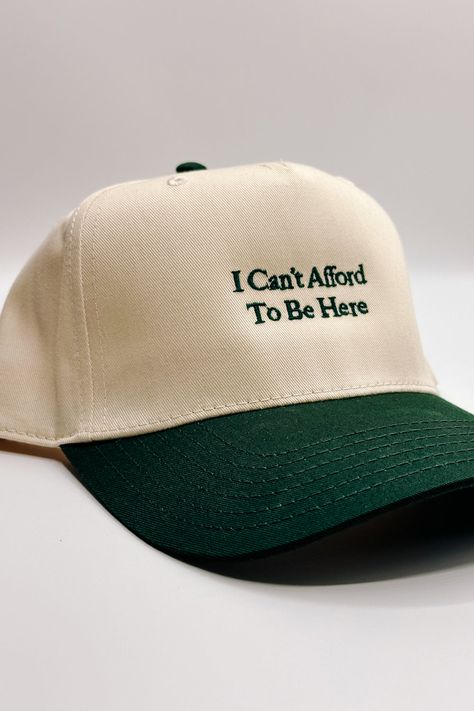 Introducing the I Can't Afford To Be Here" Trucker Hat, a witty and lighthearted accessory for your everyday adventures. This hat features a beige body adorned with bold dark green embroidery that humorously declares "I Can't Afford To Be Here." The dark green bill adds a contrasting touch, while the adjustable back ensures a comfortable fit. On the back of the hat, you'll find the embroidered phrase "The Happiest :)" to add a touch of whimsy. Perfect for those who appreciate humor and want to a Crochet Trucker Hat, Embroidered Hat Ideas, Trucker Hat Style, Embroidered Trucker Hats, The Hood Aesthetic, Trucker Hat Designs Ideas, Trucker Hat Ideas, Dark Green Embroidery, Trucker Hat Designs