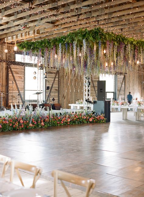 Blue, lavender, purple, pink delphinium ceiling installation chandelier Dance Floor Flower Installation, Floral Roof Installation Wedding, Dance Floor Chandelier, Wedding Ceiling Installation, Ceiling Installation Wedding, Ceiling Floral Installation, Wisteria Ceiling, Blue Delphinium Wedding, Pastel Pallet