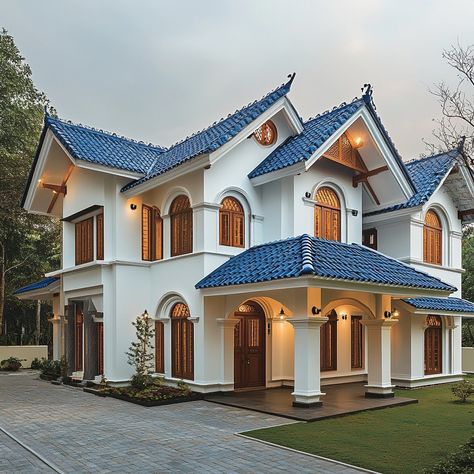 Where modern meets tradition in perfect harmony! 🏡✨ This two-story home features a striking blue-tiled roof and arched wooden windows that bring a touch of classic Indian charm to contemporary design. With its elegant white exterior and contrasting accents, this house stands out as a beacon of style and functionality. 🌿🚗 #ModernIndianArchitecture #HomeDesign #ArchitecturalElegance #TraditionalElements #ContemporaryLiving #StylishHomes #GardenViews #HomeInspiration Blue Roof Tiles, Mothers Love For Her Son, Blue Roof, Wooden Tile, Home Features, White Exterior, Wooden Windows, Indian Architecture, Roof Tiles