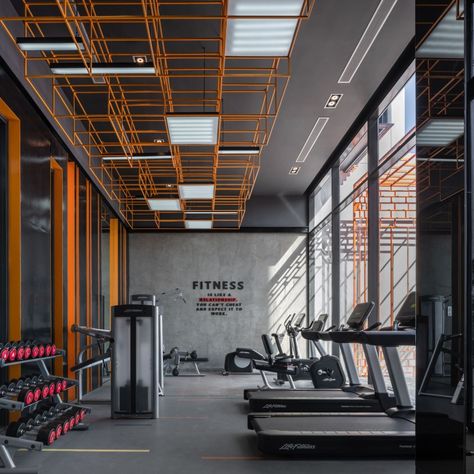 The LINE Sukhumvit 101 (I) Interior | Wison Tungthunya & W Workspace Industrial Gym Design, Fitness Interior Design, Gym Interior Design Ideas, Fitness Interior, Fitness Flooring, Orange Gym, Fitness Center Design, Gym Lighting, Gym Design Interior