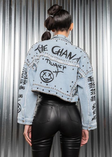 Take your look from basic to bold with this studded denim jacket! This classic jean jacket style gets a rad update with studs and graffiti design in the front and back. The cropped length completes the edgy vibe of this trucker jacket that is made from lightly washed denim. Available in sizes S, M, L and XL. Made out of 100% cotton. Add some edge to your outfit with this casual-cool jean jacket designed in a perfectly relaxed fit. It pairs well with anything in the wardrobe, so the possibilities Graffiti On Denim, Graffiti Jean Jacket, Graffiti Jacket, Jean Jacket Design, Graffiti Fashion, Jean Jacket Styles, Weird Style, Custom Jean Jacket, Studded Denim Jacket