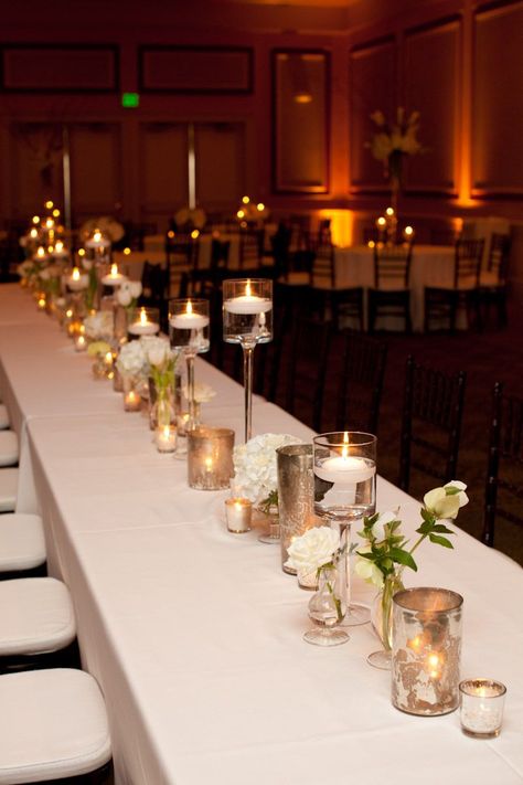 head table floating candles - Google Search Gold Floating Candles, 8 Foot Table, Floating Candles Wedding, 50th Anniversary Decorations, Luke Wilson, Floating Candle Centerpieces, White Wedding Decorations, 50th Anniversary Party, Candle Holders Wedding