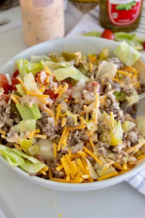 We combine ground beef, cheese, pickles, tomatoes, onions and a homemade zesty burger sauce to dress it with...all the flavors you love of a burger but none of the guilt! Salads With Hamburger Meat, Hamburger Salad Recipes, Burger Salad Dressing, Hamburger Salad, Hamburger Salad Bowl, Cheese Burger Salad, Pioneer Woman Cheeseburger Salad, Cheeseburger Salad Bowl, Healthy Cheeseburger Salad