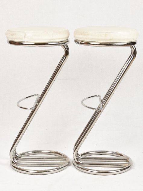 A stylish set of four chrome 'Z' shaped bar stools with footrests from the 1980s. It is recommended that they are reupholstered as there is a tear in one chair, and the faux leather is rather tired. Approx. overall 13¾" diameter x 30¾" high Approx. overall 35cm diameter x 78cm high High Stool Design, Bar Chair Design, High Stools Kitchen, Bar Stools Metal, Bar Stool Design, 80s Furniture, Bar Chairs Design, Chrome Furniture, Chrome Decor