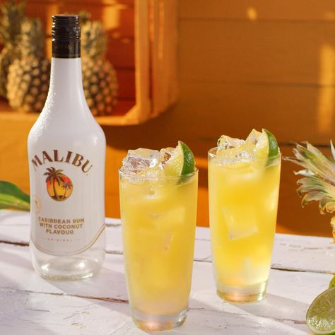 Create the perfect Malibu and Pineapple with this step-by-step guide. Fill a highball glass with ice cubes. Add malibu rum. Top up with pineapple juice. Garnish with a lime wedge. Malibu Rum, Pineapple Juice, Lime Cocktails With Malibu Rum, Malibu Rum Drinks, Malibu Pineapple, Malibu Cocktails, Vodka And Pineapple Juice, Rum Drinks Recipes, Malibu Drinks, Coconut Mojito, Pineapple Vodka