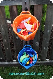 Outdoor toy storage.  Hang buckets up on the fence to store toys on your preschool playground. Pool Organization, Pool Toy Storage, Outdoor Toy Storage, Preschool Playground, Outdoor Organization, Pool Storage, Sand Toys, Outdoor Classroom, Backyard Playground