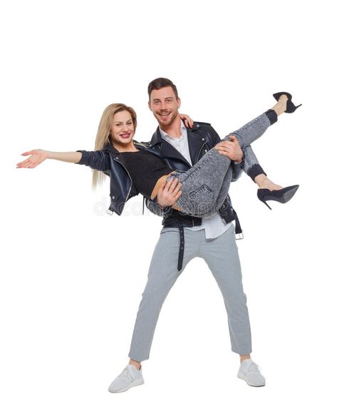 A man is holding a woman in his arms. A men is holding a women in his arms. Smiling couple front view. The guy is wearing his girlfriend in his arms. Isolated on royalty free stock image Man Carrying Woman, About Relationship, In His Arms, Couple Poses Reference, People Poses, Human Reference, Human Poses Reference, Figure Poses, Poses References