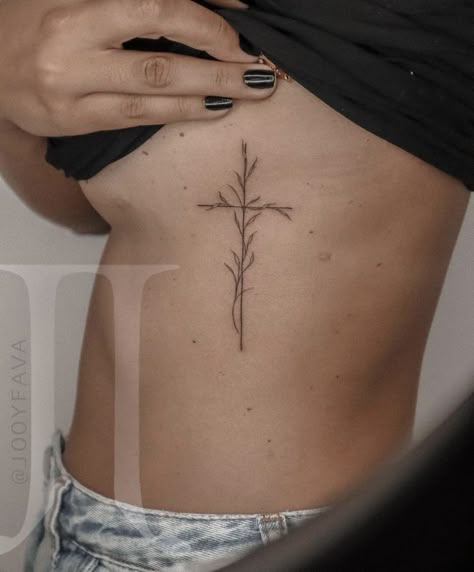 Cross With Grapevine Tattoo, Cross And Olive Branch Tattoo, Bible Verse Tattoo Ribcage, Cross With Leaves Tattoo, Cross And Vine Tattoo, Cross With Olive Branch Tattoo, Rib Cross Tattoos For Women, Small Cross With Flowers Tattoo, Spine Cross Tattoo