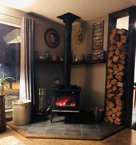 Woodburner Stove Ideas, Wood Stove In Cabin, Corner Wood Stove Ideas Mantels, Small Cabin Wood Stove, Fireplace With Wood Stove Insert, Corner Wood Stove With Wood Storage, Wood Stove Aesthetic, Small Wood Burning Stove Corner, Raised Wood Stove Hearth