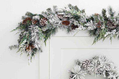 Use these six clever tips and tricks to easily hang a festive holiday garland in your home without damaging any of the walls. Garland On Wall, Exterior Door Frame, Garland Hanger, Small Writing Desk, Mounting Putty, Cinder Block Walls, Holiday Garland, Charming Kitchen, Green Garland