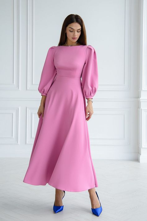 Emanate an air of enchanting grace in ELAGIA's Dusty-Pink Backless Puff Sleeve Midi Dress, a vision of loveliness and allure. The soft, romantic hue combined with the charming puff sleeves and an alluring backless design creates an ensemble that embodies feminine elegance. This dress is a delightful symphony of charm, perfect for exuding an irresistible, lovely allure. #dustypinkdress #puffsleeves #backlessdesign #feminineelegance #romanticensemble #lovelylook #womensfashion Pink Modest Dress, Dusty Pink Outfits, Satin Pink Dress, Soft Pink Dress, Modest Midi Dress, Dusty Pink Dresses, Satin Formal Dress, Wedding Dress Outfit, Feminine Elegance