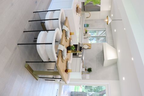 Sleek & Modern - This kitchen feels like a warm oasis, a timeless and inviting classic. When designing this kitchen, our top priority was functionality. The centrepiece of this project is it’s stunning waterfall countertop on the island. We attached this beautiful custom white oak dining table, with brass legs to tie in the whole look, and give our client a cozy area for dining. Kitchen Island With Built In Dining Table, Kitchen Island Eat In Table, Dining Table Beside Kitchen Island, Island Attached To Table, Countertop Table Kitchen Islands, Island And Dining Table Combo Modern, Dining Table Next To Island, Kitchen Island With Dining Seating, Kitchen Island With Dining Table Ideas