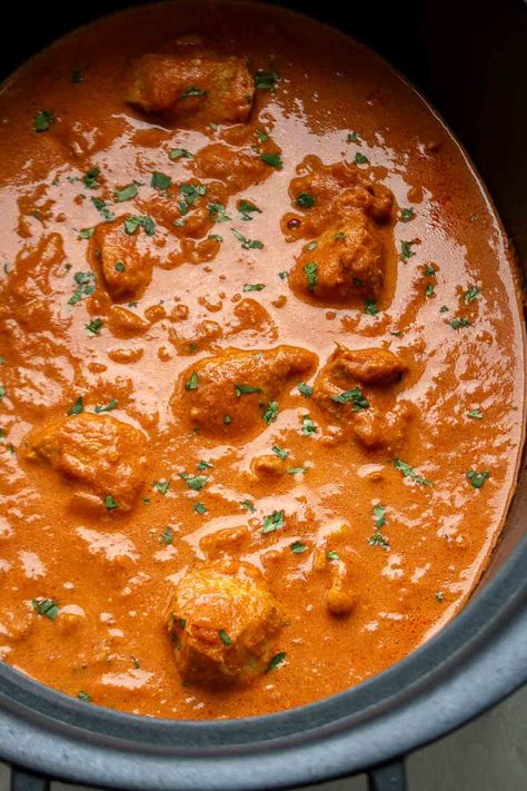 Made with chicken thighs, spices, tomatoes, and heavy cream, this slow-cooker butter chicken recipe is easy to make and full of flavor. Chicken Thigh Indian Recipes, Slow Cooker Chicken Thighs Recipes, Chicken Thigh Recipes Slow Cooker, Chicken Thigh Slow Cooker Recipes, Slow Cooker Chicken Thigh Recipes, Chicken Thighs Slow Cooker, Crockpot Butter Chicken, Chicken Thighs Slow Cooker Recipes, Butter Chicken Slow Cooker