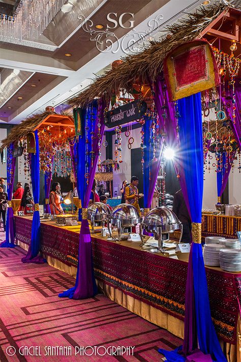 Wedding Food Enhancements. Thatched Food Hut (Double). ---------- #decorbysuhaaggarden #thatchedfoodhut #suhaaggarden #stylingwithjilna #garbadecor #suhaaggarden #stylingwithjilna #enchanteddecor #intelligentlights #garbacenterpiece #centerpiece #indianwedding #southasianwedding #garbafunction #weddingtents #weddingphotographer #weddingphotography #luxuryweddings#indianweddingdecor #shaadisaga #wedmegood #indoorgarbadecor #newyorkweddings #floridaweddings #thatchedfoodhut #foodenhancements Event Food Stations, Indian Wedding Food, Marriage Vision Board, Buffet Setup, Wedding Food Table, Market Lights, Wedding Buffet Food, Food Tables, Wedding Food Stations