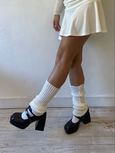 white leg warmers, white tennis skirt, black mary janes, neutral tones, black and white aesthetic Leg Warmer And Mary Janes, Mary Jane Shoes With Leg Warmers, Mary Janes Leg Warmers, Mary Janes With Leg Warmers, Leg Warmers And Heels, Chunky Mary Janes Outfit, Mary Janes With Socks, Black Mary Janes Outfit, Mary Janes Aesthetic