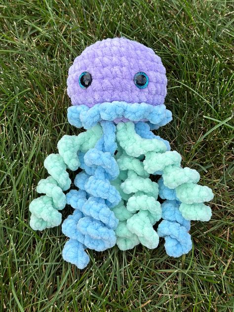 Adorable handmade crochet jellyfish plushie! Don't miss out on this unique one of a kind creation. The plushie in the photos is the exact plushie you will receive. Perfect gift for any occasion! Made with soft chenille yarn and plastic safety eyes. The eyes are a choking hazard. This is a decorative item not intended for small children or animals. Jellyfish pattern by @ Plushie Amigurumi Free Pattern, Chenille Yarn Projects, Chenille Yarn Crochet Patterns, Crochet Jellyfish Plushie, Crochet Pattern Jellyfish, Crochet Stuffys, Crocheted Plushies, Jellyfish Crochet Pattern, Small Crochet Jellyfish