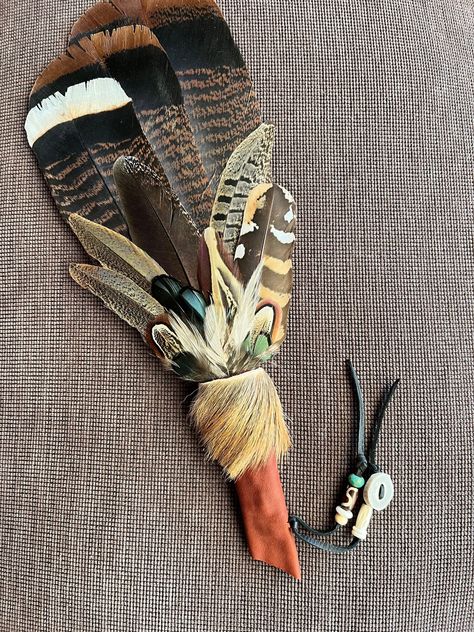 Deer Spirit smudge wand is light and powerful, a good one to work with for the medicines of sensitivity and intuition.  May this smudge fan help you fully inhabit your power with grace and gentleness. I will make this feather fan especially for you. No two are ever exactly alike due to the natural materials.  Deer Spirit of tends to be about 14 inches in length, with wild turkey tail, pheasant, and rooster feathers, hair-on deer pelt, with deer leather handle, suede toggles and deer antler beads.  Each of my smudge fans is a unique creation of earth magic! In addition to use in the smudging ceremony, they are beautiful mounted on the wall, as part of an altar space or personal shrine, or as a shamanic gift for someone who values healing tools and connection to nature.  This feather fan is Foraging Crafts, Deer Spirit, Smudging Ceremony, Antler Beads, Smudge Fan, Smudging Feathers, Pagan Prayer, Native American Feathers, Medicine Man