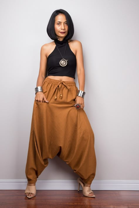 "Brown harem pants | Unisex cotton pants | Loose fit brown trousers | Summer festival pants PRODUCT SIZE : One Size Fits Most * Waist : up to 40\" (elastic all around) * Hips : up to 48\" * Length from waist to hem : 38\" * Length from waist to crotch: 28\" * Width of legs(bottom): 12\" MATERIAL : * Cotton NOTE : * Model chest : 32\", waist : 24\" hips : 35\" * Combined Height is 5\"6 > I'm 5\"2 (158cm) and I'm wearing 4\" heels in the pictures CARE INSTRUCTIONS : Hand wash IMPORTANT NOTE *Pleas