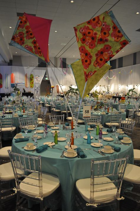 Beautiful fabric kite centerpieces  made of fabric and attached to a polished lucite base Luncheon Centerpieces, Mary Poppins Party Decorations, Fair Decorations, Kite Decoration, Kite Party, Storybook Party, Cat In The Hat Party, Mary Poppins Party, Mardi Gras Centerpieces