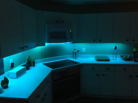 Kitchen under cabinet LED strip lighting. Very cheap and fun. Led Light In Kitchen, Led Lights Under Kitchen Cabinets, Led Light Kitchen, Led Lights In Kitchen Under Cabinet, Led Kitchen Lighting, Apartment Kitchen Lighting, Strip Lights In Kitchen, Lights Under Cabinets, Led Lights Kitchen Under Cabinet