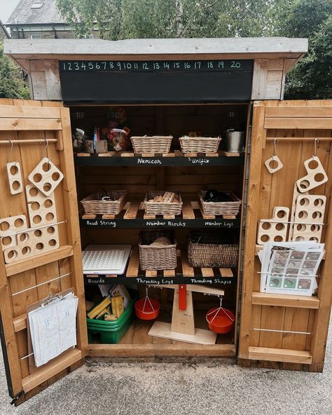 Welcome to the Maths Counting Shed – where outdoor fun meets numeracy! 📚🌳 Picture your students rushing to the shed, excited to explore its treasures.✨ Easy-access lower shelves for everyday resources and higher ones for special items. The cupboard doors are perfect for chalk writing – numbers, art, or smiley faces! ✏️😊 From counting pebbles to organizing shapes, it turns playtime into a numeracy adventure and keeps everything tidy – no more tripping over counters or losing pieces! 📸@all... Den Building Eyfs Outdoor Play, Outdoor Writing Area Eyfs, Eyfs Outdoor Area On A Budget, Eyfs Outdoor, Eyfs Outdoor Area, Year 1 Classroom, Numbers Art, Eyfs Ideas, Early Years Maths