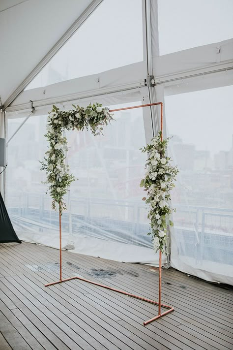 Copper Arch with White and Green Floral Arrangements | Rooftop Wedding Ceremony Wedding Arch Metal Frame, Metal Arch Decor, Rectangular Arch Wedding, Black And White Ceremony Backdrop, White And Green Floral Arch, Metal Arch Decoration Wedding, Metal Wedding Arch Ideas, White And Copper Wedding, Rectangular Wedding Arch