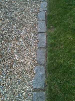 Cobble transitions. Although this cobble make a nice clean edge to the gravel patio it also accomplishes a nice transition area between lawn and gravel areas. Terrascapes Landscape Design. Patio To Lawn Transition, Gravel Parking Area In Front Of House, Gravel To Grass Edging, Mountain Driveway, Cobble Edging, Edging For Gravel Driveway, Gravel Driveway Landscaping Edging, Gravel Parking Pad, Landscape Transitions