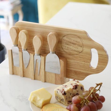 A wooden dinner set for any gathering or celebration, finished with a personalised engraving. From Lisa Angel. This cheese board and knife set has everything you need to serve your guests their favourite cheeses the way they should be served! The personalised set includes a wooden board with handle, four tools with stainless steel blades for slicing, spreading, and smearing cheese, and a stand that houses the board and knives neatly once you're feast has ended. The board is finished with your ow Dinner On The Go, Personalized Cheese Board, Lisa Angel, Present For Him, Wooden Cheese Board, Chopping Boards, Wood Ideas, Cheese Serving, Presents For Him