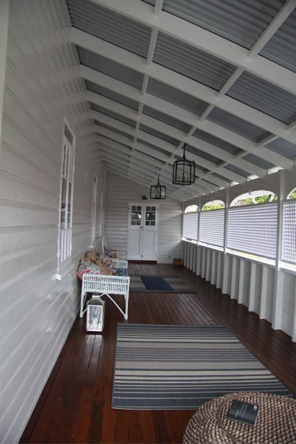 Queenslander home enclosed verandah Beautiful dark timber decking  and white colours on the weatherboard of the home along with the white lattice screening the verandah.  All complimented with grey colorbond roof. Just perfect for Australian conditions. #deck #patios #verandah #roofing Workers Cottage, Queenslander Renovation, Queenslander House, Weatherboard House, Front Verandah, Roof Architecture, Patio Roof, Pergola Plans, Style Tile