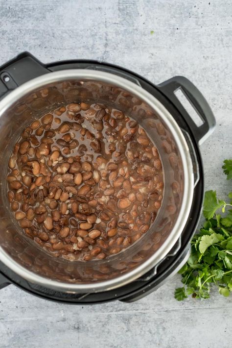 An overhead picture of cooked pinto beans in an Instant Pot with cilantro to the side. Instant Pot Pinto Beans, Instant Pot Beans Recipe, Pressure Cooking Today, How To Cook Beans, Electric Pressure Cooker, Pinto Beans, Dried Beans, Cooking Method, Cooking Pot