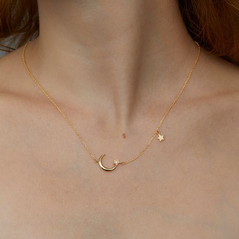 Embrace celestial elegance with our enchanting Moon and Star Necklace, designed to add a touch of whimsy and sparkle to your jewelry collection. This stunning piece features a delicate 14K gold-plated chain adorned with a crescent moon and star pendant, both encrusted with shimmering cubic zirconia stone. Perfect for any occasion, this necklace is a timeless symbol of beauty and grace. Key Features: *Moon and Star Pendant: The necklace showcases a beautifully crafted crescent moon and star penda Jewelry Necklace Simple, Glamour Jewelry, Star And Moon Necklace, Gold Moon Necklace, Celestial Necklace, Moon Pendant Necklace, Gold Moon, Moon Necklace, Star Pendant