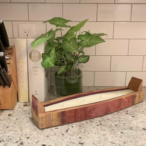 This unique vessel candle is crafted from reclaimed wine barrel staves then hand poured with soy wax. Barrel Stave Candle Holder, Wine Barrel Wood Projects, Whiskey Barrel Crafts, Painted Barrel Staves, Bourbon Barrel Stave Projects, Wine Barrel Candle Holder, Barrel Stave Projects, Wine Bottle Holder Wall, Barrel Stave Ideas