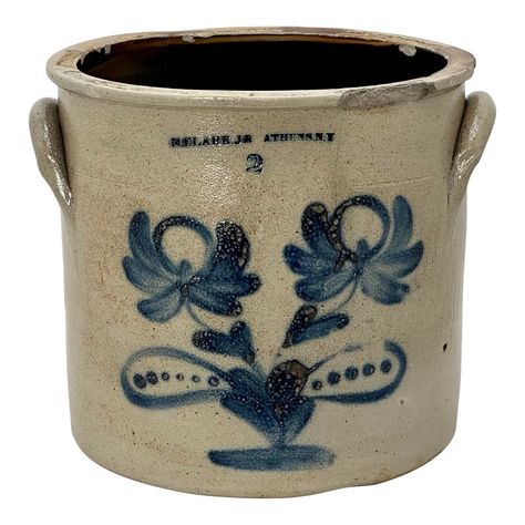 This Really is a Great Looking Authentic Antique American Primitive Stoneware Storage Crock. Circa Mid 19th Century. It has a Classic American Rusty Sand Color Salt Glaze Exterior. The Front has a Very Large and Beautiful Blue Hand Decorated Stylized Double Flower Design. The Front is Embossed with the Well Documented Makers Name - N. CLARK JR - ATHENS NEW YORK. It is Also Embossed with the Number 2 Denoting it Two Gallon Storage Capacity. These type of Crocks were Commonly Used to Store a Variety Food and Other Items. It is in Strong - Sound - Usable Condition - No Structural Cracks - Displays Very Nicely. Imperfections Noted - It has an Assortment of Age and Use Related Chips at the Top Rim Perimeter. NOTE That the Largest Top Rim Chip Above the Right Flower is Glazed Over Confirming tha Pickers Antiques, Variety Food, Antique Stoneware Crocks, Country Crock, Old Crocks, American Primitive, Stoneware Crocks, Antique Stoneware, Potter Art