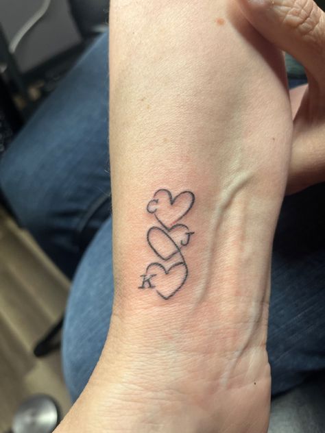 As a single mom, I got this tattoo with oldest child first, me, and then youngest child. Small Tattoos For Daughter, Small Tattoo Ideas Family, Nice And Nephew Tattoos, Childs Initials Tattoo, Tattoo For Niece, Tattoo For Niece And Nephew, Children Initial Tattoos For Moms, Tattoo Ideas For Siblings Names, Middle Child Tattoo