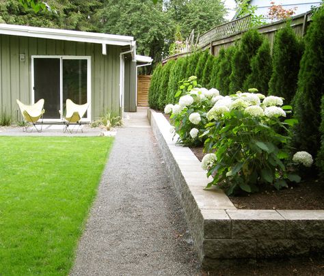 Third Nature Studio | Hydrangeas in raised bed, Midcentury Ranch Rustic Raised Garden Beds, Stone Raised Beds, Midcentury Ranch, Stone Flower Beds, Landscape Ideas Front Yard Curb Appeal, Landscaping Along Fence, Garden Retaining Wall, Raised Flower Beds, Mid Century Ranch