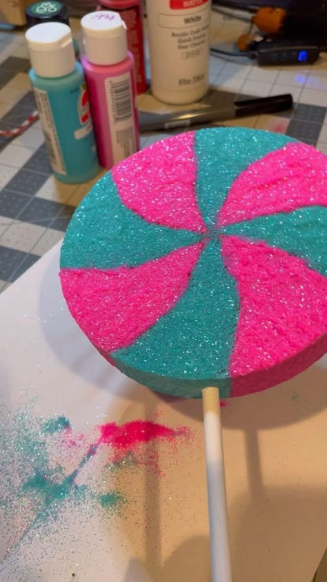 I have a new FREE tutorial on how you can make these awesome glittered fake lollipops!  Best yet is you don't even have to glitter them if you don't want to...but we always go for more bling the better!

Now you can watch as many times as you want to make as many of them as you want...and in whatever color combo you want too!  Most of the items came right from the Dollar Tree!

So start your fake bake journey with something a little "sweet" like these fake lollipop accents! Candy Tutorial, Make Candy Decorations, Candy Land Props, Candyland Yard Decorations, Candy Land Decorations Diy How To Make, Christmas Lollipops Diy, How To Make Candy Props, Giant Candyland Decorations, Christmas Candyland Decor