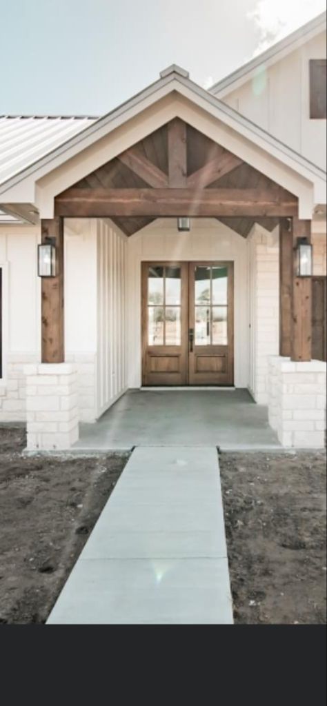 White House Oak Trim Exterior, White Brick Board And Batten Exterior, Exterior Home Ideas Farmhouse, Neutral Home Outside, Modern Farmhouse Exterior Board And Batten, White House With Rock Accents, White Houses With Wood Accents, White Farmhouse Wood Accents Exterior, Cream And Wood Exterior House