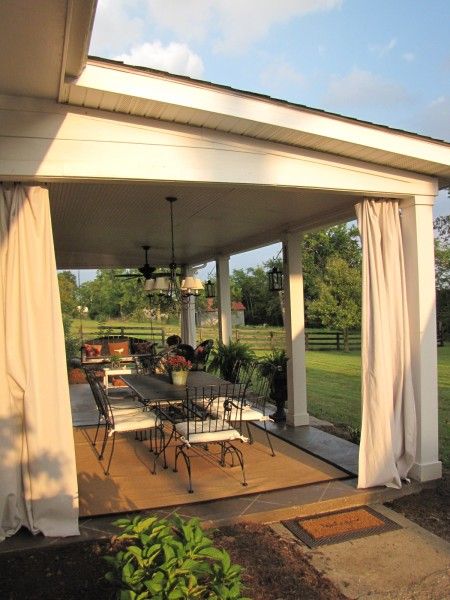 patio makeover: stained concrete slab with diamond tile pattern, lanterns hanging on posts, curtains Patio Privacy, Patio Curtains, Backyard Porch, Patio Diy, Patio Roof, Patio Makeover, Pergola Patio, Patio Lighting, Concrete Patio