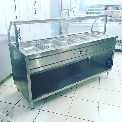 Locally made stainless steel food warmer with curved glass sneeze guard , 5 full pans capacity , bain marie type utilizing a water-immersed heater , thermostat controlled with an indicator light , sneeze guard has a T5 lighting for better display illumination , drain tap on water tank for easy cleaning , food grade 304 stainless steel construction. Available here or upon order.  For your food service or food business inquiries, please contact us at: 0917 301 2331 (Globe.Manager) 0943 533 3291 (S Bain Marie Food Display, Buffet Equipment, Food Warmer Display, Commercial Kitchen Appliances, Food Warmer Buffet, Restaurant Kitchen Design, Steel Furniture Design, Kitchen Appliances Design, Grocery Store Design