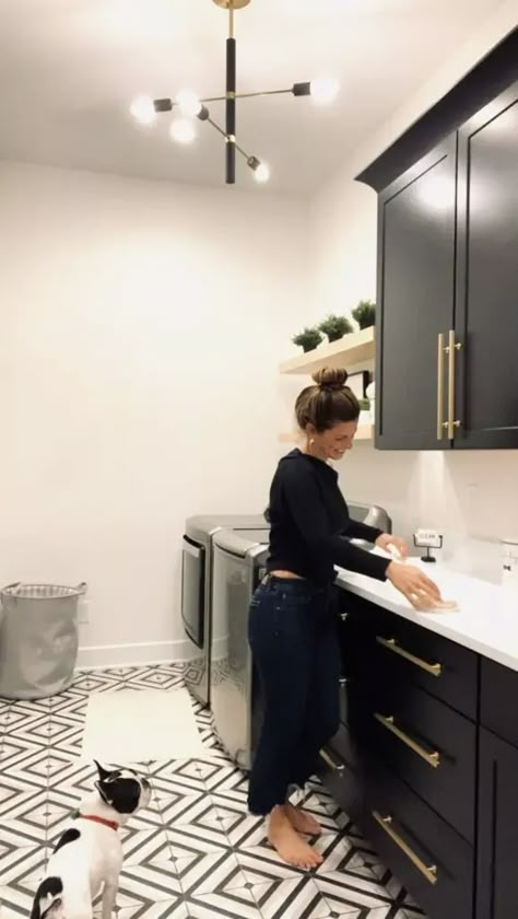 Laundry Room Next To Garage Door, Lvp Laundry Room, Laundry Room Ideas Black Cabinets, Laundry Room Black Tile Floor, Black White And Gold Laundry Room, Laundry Room With Black And White Tile, Black Cabinet Laundry Room Ideas, Black Laundry Cabinets, Iron Ore Laundry Room Cabinets