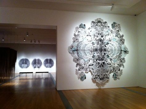 “Mandala” is a large sculptural endeavor of a colossal scale equal to that of Alexander’s “The Tempest.” Svoboda uses dozens of sheets of Japanese rice paper transformed by ink washes to create a large abstract collage that allows us to loose ourselves to the power of pattern, symmetry and scale. Yet again, the notions of fragility we would normally associate with the material dissolve and we are left to admire something of collective power. In a new fashion, she succeeds in achieving the illusi Rorschach Art, Fractal Geometry, The Tempest, Abstract Collage, Japanese Rice, Charcoal Art, Ink Blot, Stencil Art, Japanese Paper