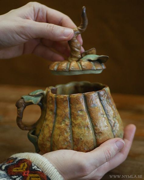 A yellow/brown mug in the shape of a pumpkin, with a grey fabric background. Pumpkin Pottery, Artwork Sculpture, Autumn Mug, Pumpkin Mug, Ceramic Pumpkin, Pottery Form, All Hallows Eve, Hand Built Pottery, Orange Pumpkin