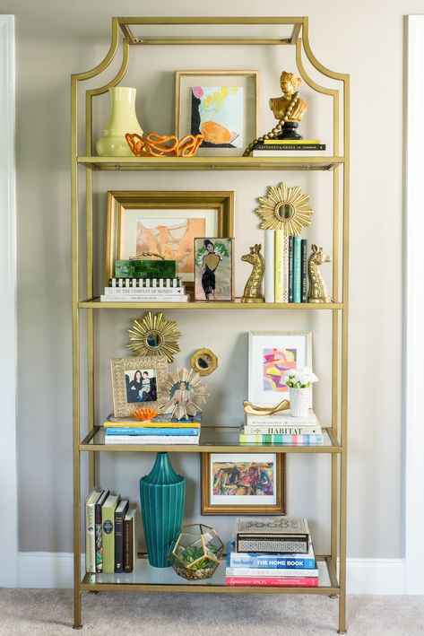 Gold Glass Bookshelf, Gold Shelves Decor, Gold Shelf Decor Bedroom, Gold Display Shelf, Glass Etagere Styling, Gold Bookcase Living Room, Gold And Glass Bookshelf, Gold Bookshelf Decor Living Room, Entry Way Book Shelf