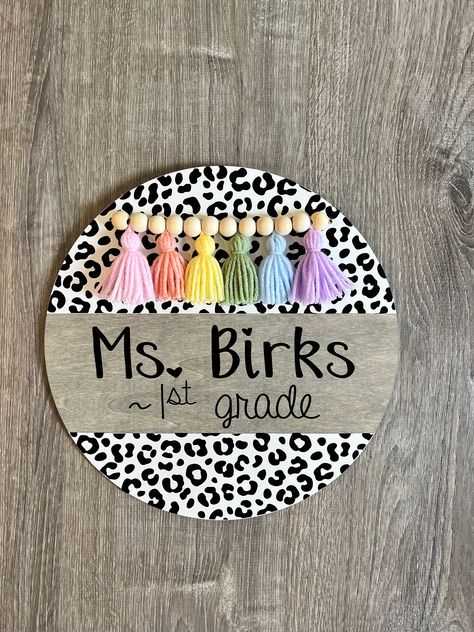 White Leopard door hanger🐆 with pastel rainbow tassel 🖤 All signs are made from real wood that is 1/4" thick! Size options: 12"      14"      18" Shut The Door Sign, Wooden Teacher Signs, Leopard Door Hanger, Butterfly Door Hanger, Round Teacher Door Hanger, Classroom Door Hangers, Cricut Project Ideas, Teacher Door Hanger, Office Door Signs