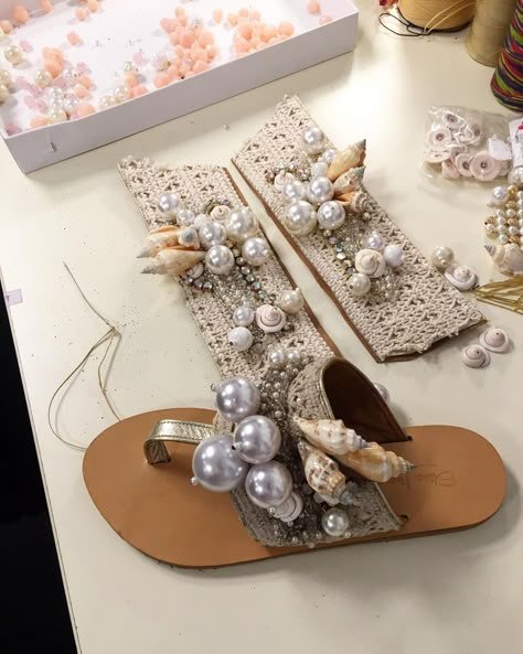 Elina Linardaki’s Instagram photo: “Making of one of our most magical designs, the Calypso sandals✨Made with crystals, seashells and pearls, stiched onto a cream lace💫🌙⭐️🐚” Pearl Sandals, Diy Sandals, Embroidery Shoes, Diy Slippers, Fashion Shoes Sandals, Beaded Sandals, Handmade Sandals, Cream Lace, Shoe Clips