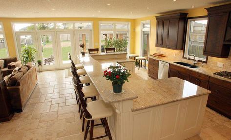 Ahmann suggests leaving at least 12 inches of overhang for island seating areas, but 15 to 18 inches tends to feel more comfortable. #traditionalkitchen U Shaped Kitchen Island, Kitchen Island Shapes, Upstairs Kitchen, Kitchen With An Island, Yellow Cabinets, Kitchen Island Bar, Traditional Kitchen Design, Kitchen Island With Seating, U Shaped Kitchen