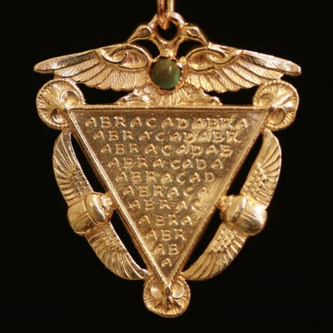 Victorian era amulet with Egyptian symbols and turquoise. Abracadabra: this word is of ancient origins. In a poem on occult medicine written by a pagan doctor in ancient Rome about 250 AD, to ward off fevers and sickness, the physician recommended the word abracadabra be written down in an inverted triangle. The word abracadabra comes from worship of the gnostic God, Abraxas. It literally means: The dead body, or corpse, of Abraxas. Esoteric Jewelry, Ancient Egyptian Symbols, Victorian Pendants, Egyptian Symbols, Magic Words, Victorian Jewelry, Ancient Egyptian, Estate Jewelry, Jewelry Inspiration