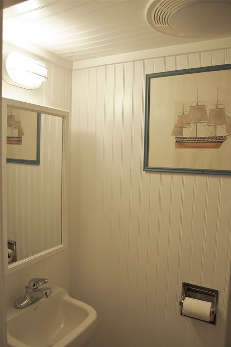 Floor to Ceiling Beadboard | small but tidy little bathroom where everything including the door, Bead Board Bathroom Ceiling, Small Bathroom Ideas With Beadboard, Beadboard Sloped Ceiling, Beadboard Wall And Ceiling, Floor To Ceiling Beadboard Bathroom, Floor To Ceiling Wainscoting Bathroom, Pvc Beadboard Bathroom, Full Beadboard Walls, Small Bathroom With Beadboard Walls